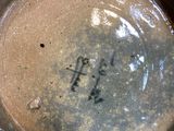 a close up of a brown vase with writing on it