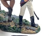 figurine of a man on a horse holding a sword
