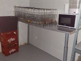 a shelf with a microwave and a lot of glasses on it
