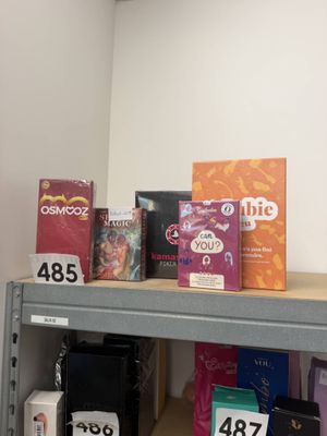 a shelf with a lot of different types of boxes on it