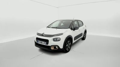 Une Citroën blanche est garée dans une pièce blanche