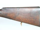 an old rifle with a wooden barrel on a white background