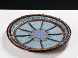 a blue and brown plate sitting on a white table