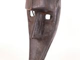 an image of a sculpture of a mask on a wooden base