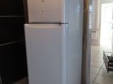a white refrigerator sitting in the middle of a kitchen