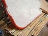 a large piece of bread sitting on top of a pile of wood