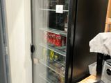 a refrigerator that is next to a counter in a kitchen