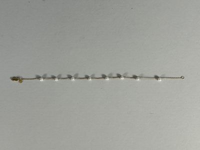 a close up of a metal chain with beads on it