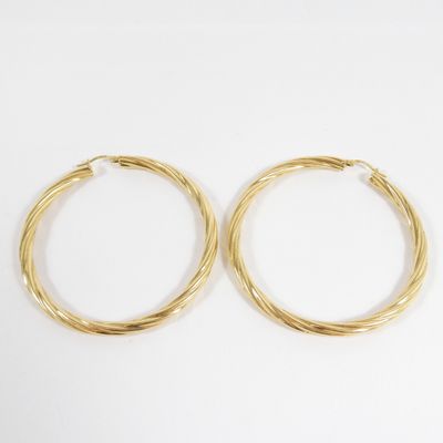 a pair of gold hoop earrings on a white background