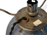 a metal lamp that has a cord attached to it