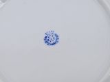 an image of a plate with a blue flower on it