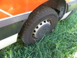 a close up of a truck tire on the side of the road
