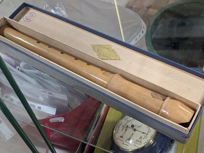 a box that has a knife in it and a clock in it