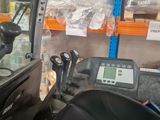 a picture of a forklift in a warehouse with a lot of items