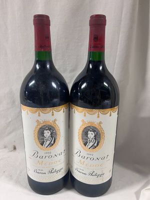 two bottles of red wine sitting next to each other on a table
