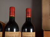 three bottles of wine sit on a table next to a box of wine