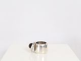a silver ring sitting on top of a white table