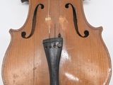 an old violin sitting on top of a white surface