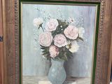 une peinture de fleurs dans un vase sur un chevalet