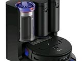 a black coffee maker with two cups on top of it