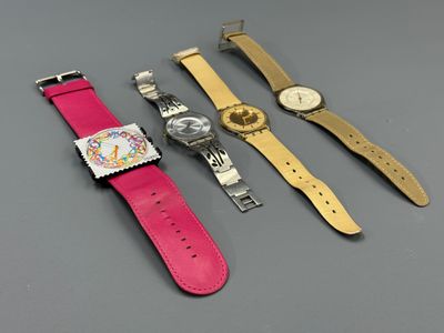 three watches are sitting next to each other on a table