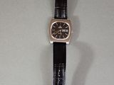 an image of a watch on a table with a black strap