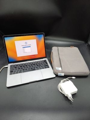 a laptop computer sitting on top of a black leather chair