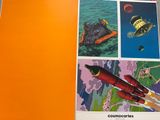an orange book with a picture of a space ship and a rocket