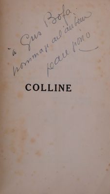an old book with writing on it sitting on a table