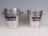 pair of silver ice buckets with handles and labels on them