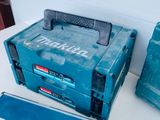 a blue tool box sitting on a table next to other tools