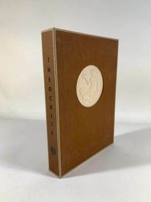 an old book sitting on top of a white table next to a white wall