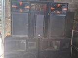 many speakers and speakers that are stacked up in a room