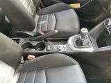 the interior of a car with black leather seats and a silver shift button