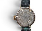 an image of a close up of a wrist watch on a white surface