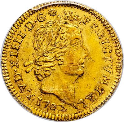 a close up of a gold coin with a crown on it