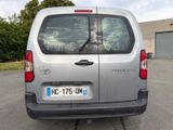 a silver van that is parked in a parking lot
