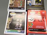 a lot of batman pop vinyl figures on the table