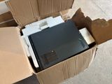 a box with a computer inside of it sitting on the floor
