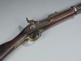 a close up of a gun on a table with a white background