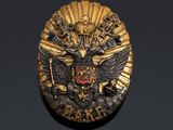 an image of a gold medal with a black eagle on it