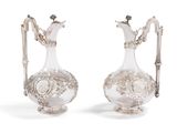 two silver plated vases with handles and handles on a white background