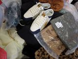 a pile of clothes and shoes on the floor