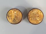 pair of gold plated cufflinks with a man and woman on them