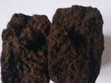 two pieces of chocolate cake sitting on a white surface
