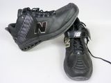 pair of new balance shoes on white surface with black soles