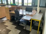 a desk with two chairs and a computer on it