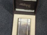 a small silver plate in a box on a table