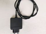 a black charger and a black cord on a white surface