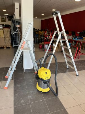 a yellow vacuum and some ladders in a room